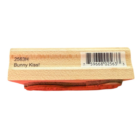 A wooden rubber stamp block with the text '2563H Bunny Kiss!' on the side and a barcode sticker, shown against a plain white background.