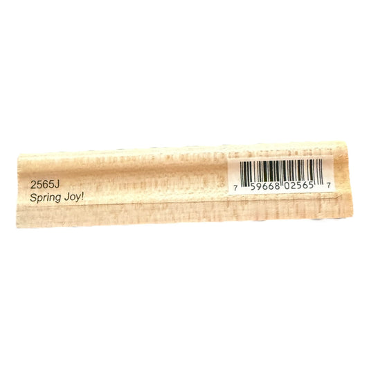 Rectangular wooden stamp with 'Spring Joy!' text and barcode on a white background
