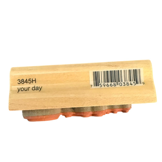 A wooden rubber stamp block with a barcode and the text '3845H your day' printed on the side, shown against a plain white background.