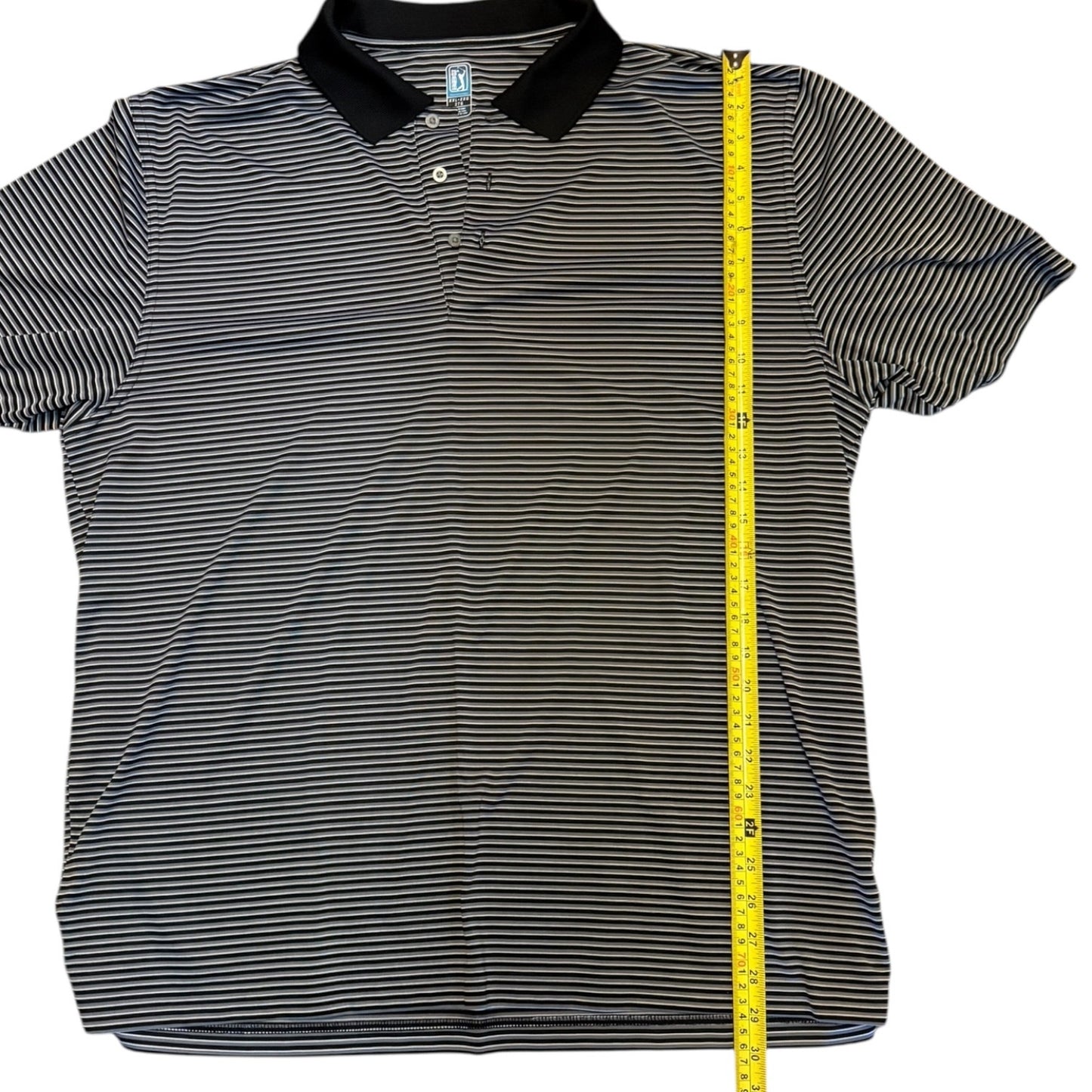 A short-sleeve polo shirt with thin horizontal black and gray stripes, a solid black collar, and a three-button placket, shown flat on a white background with a yellow measuring tape running vertically along the side.