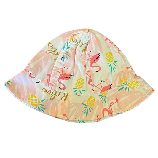 A soft fabric bucket hat featuring a tropical print with pink flamingos, yellow pineapples, and gold 'Relax' script on a white background.