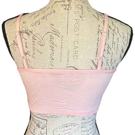 Back of light pink tank top displayed on a vintage-style fabric-covered dress form against a white background.