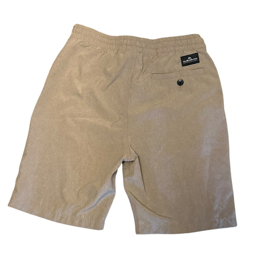 A pair of beige shorts with an elastic waistband, a back pocket with a button closure, and a small black brand label on the upper right side, shown against a plain white background.
