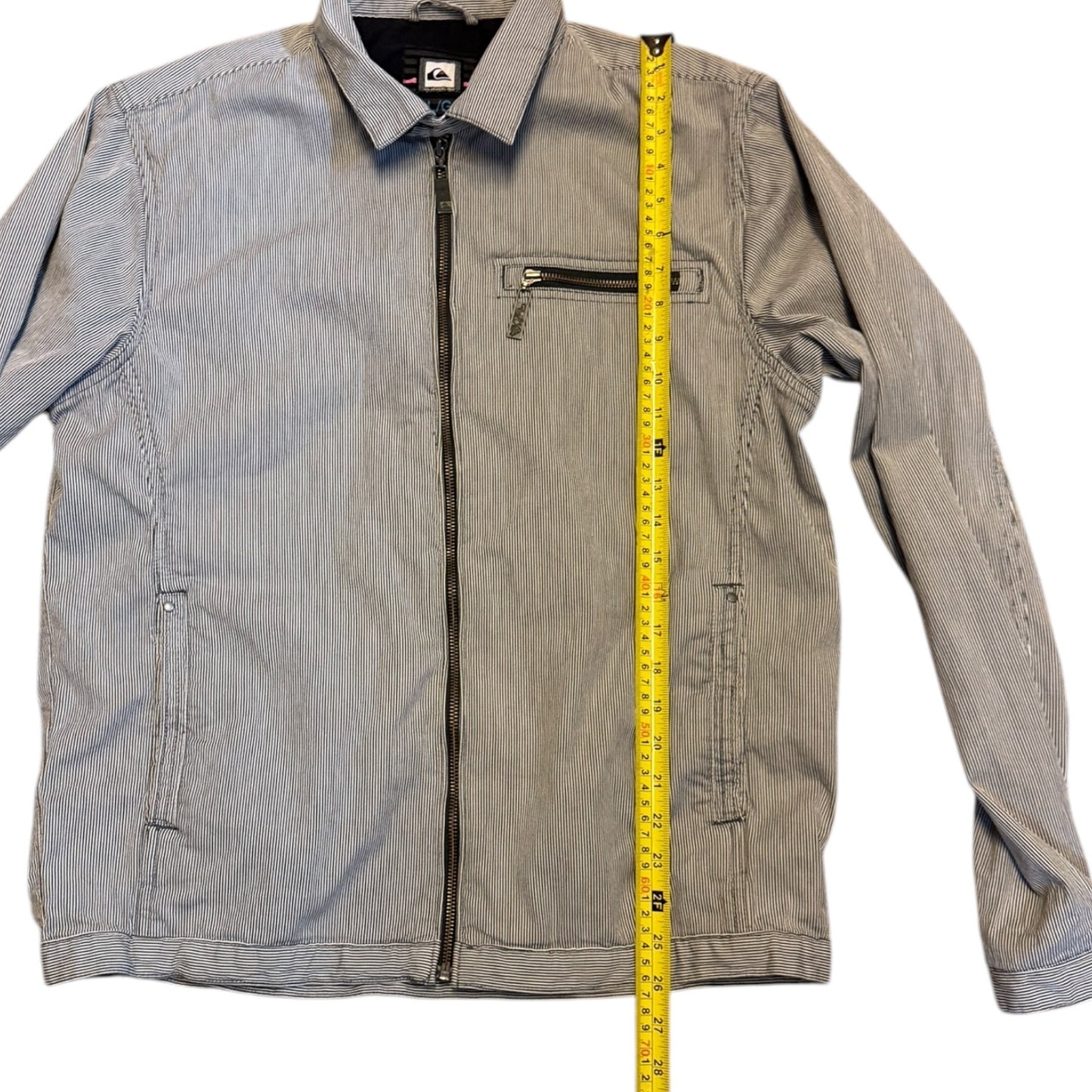 Striped jacket with a measuring tape for size reference on a white background