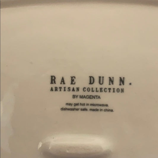 Back of Rae Dunn plate with writing
