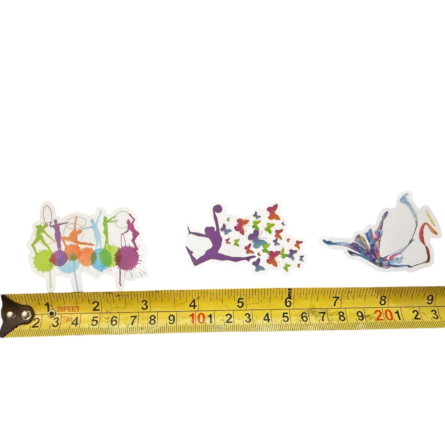 Colorful gymnastics-themed stickers with a tape measure for scale on a white background