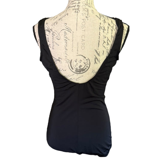 Back of black swimsuit on a form mannequin against a white background.