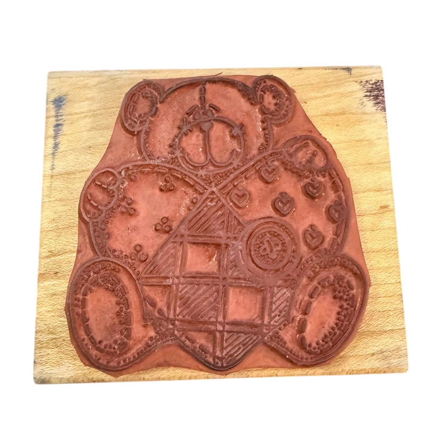 Decorative wooden stamp with intricate designs on a wooden block