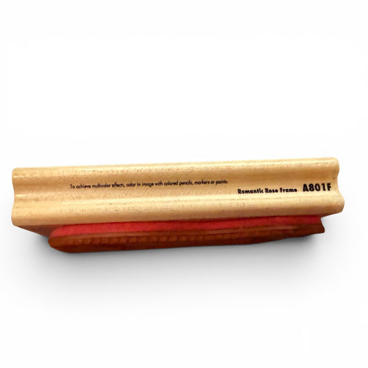 Wooden stamp with red rubber on a white background