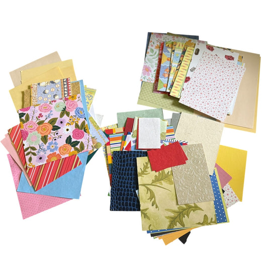 Assortment of colorful paper sheets with various patterns on a white background