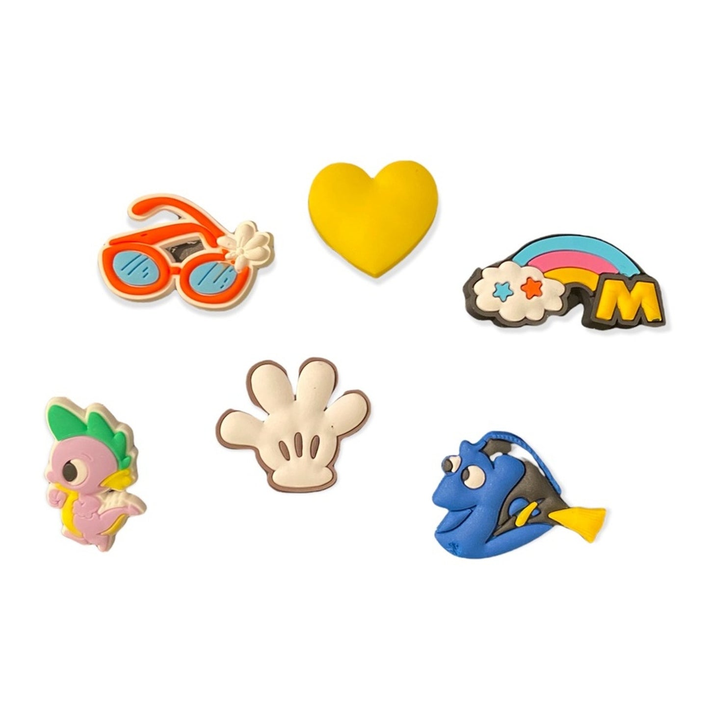 Set of colorful character-themed shoe charms on a white background