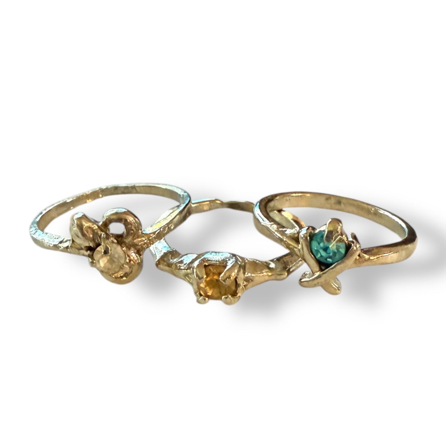 Three silver rings with assorted colored stones , displayed on a white background.