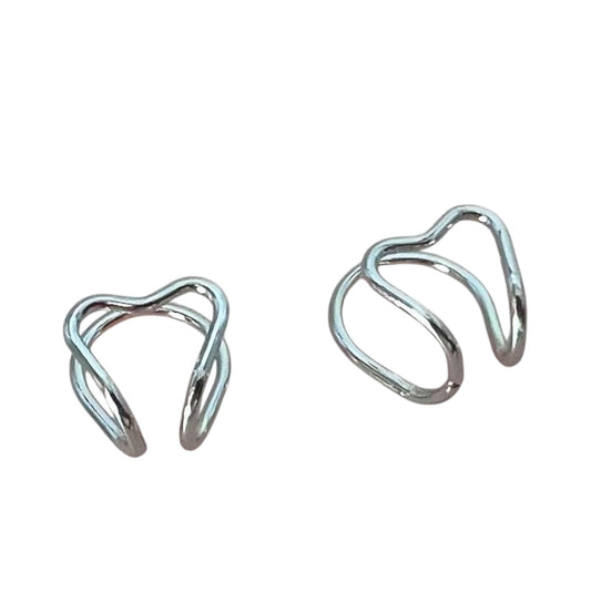 Pair of silver heart cuff earrings on a white background
