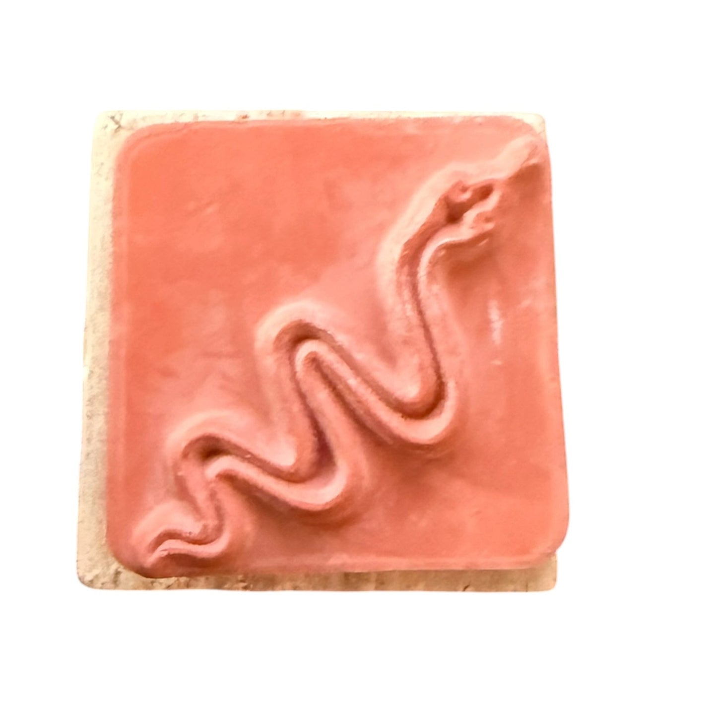Rubber stamp of a wavy snake design , set against a plain white background.