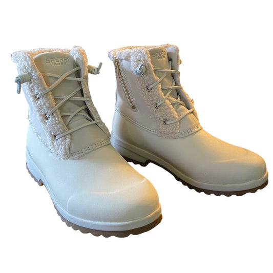 A pair of beige waterproof lace-up boots with fluffy sherpa lining around the collar, shown on a plain white background.