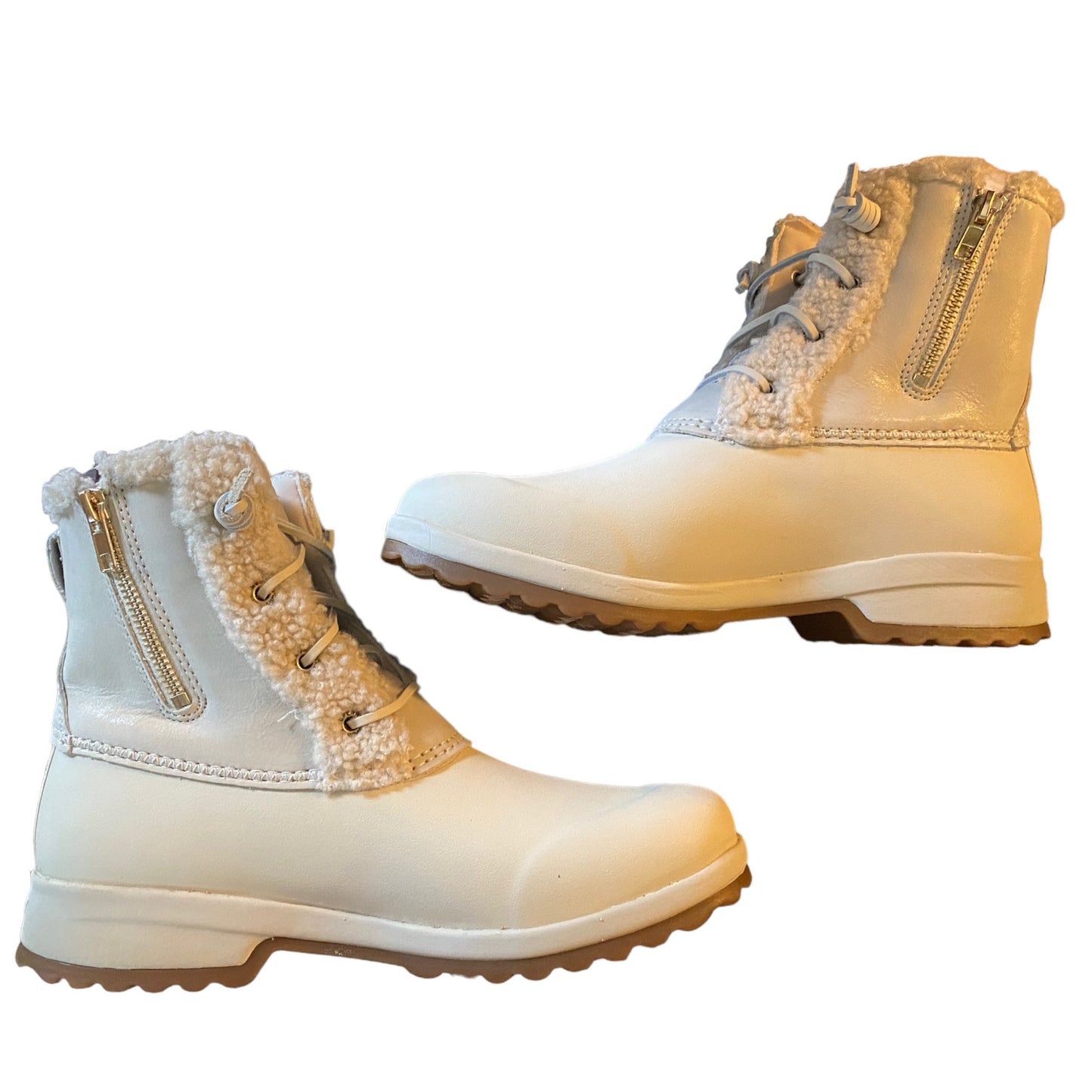 Pair of winter boots with fur trim on a white background