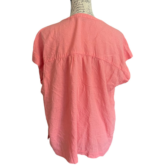 Back of Coral shirt on a mannequin against a white background