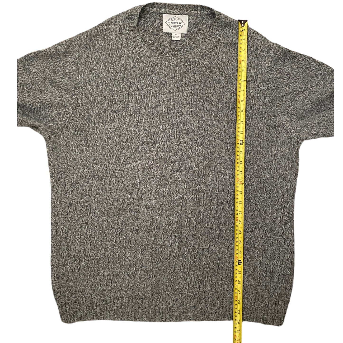 Gray textured sweater with a measuring tape on a white background