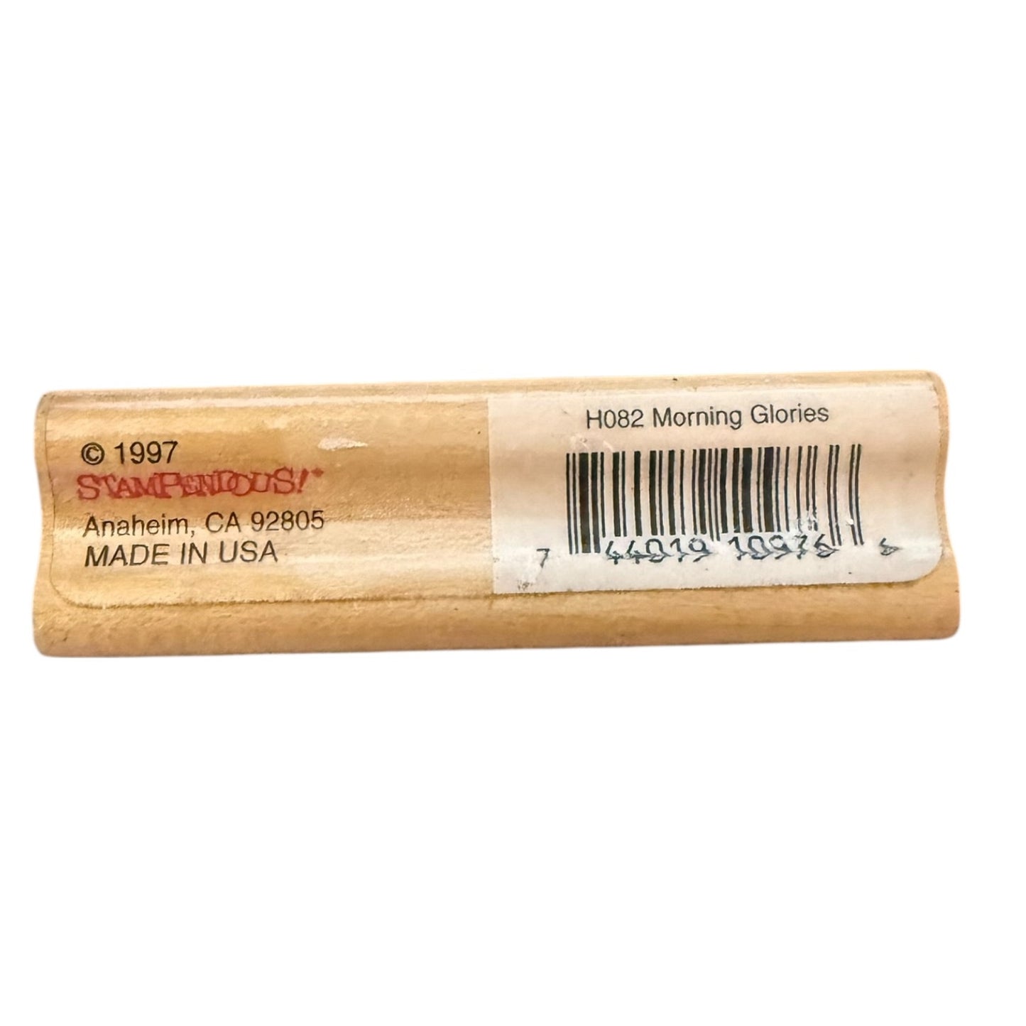 Wooden stamp block with a label on a white background