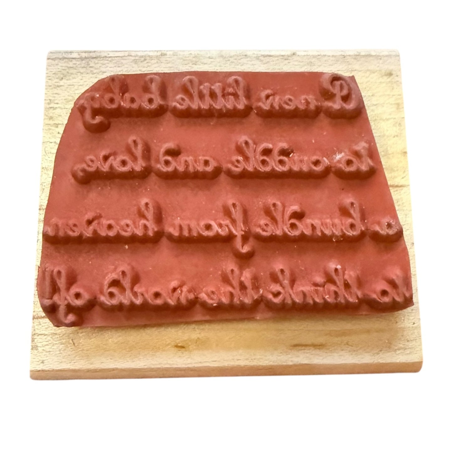 Wooden stamp with embossed text on a white background