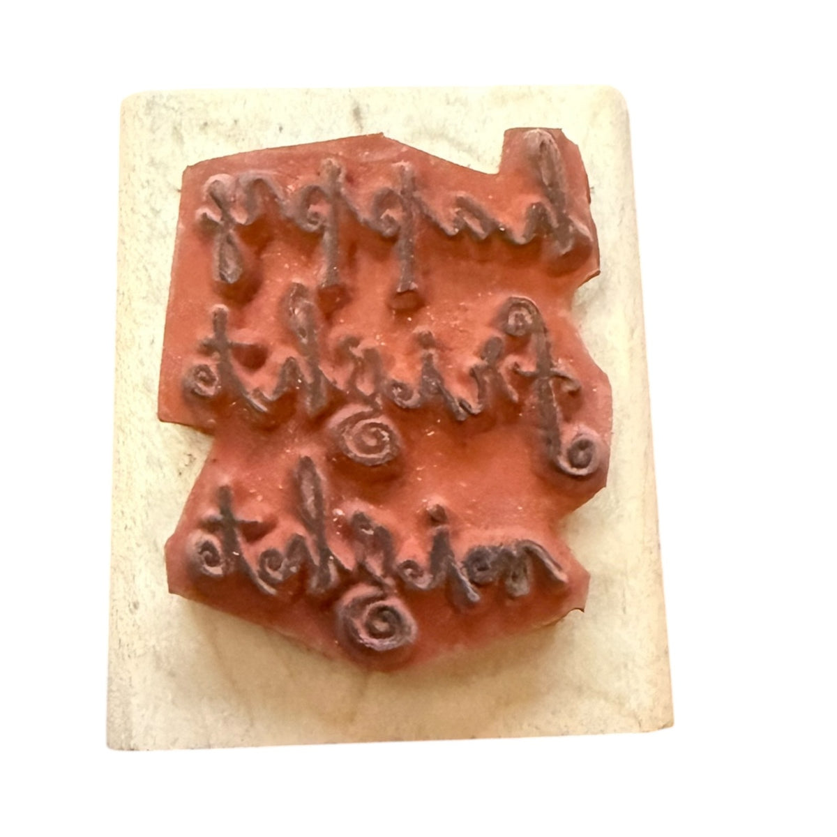 Textured stamp with embossed letters on a beige background