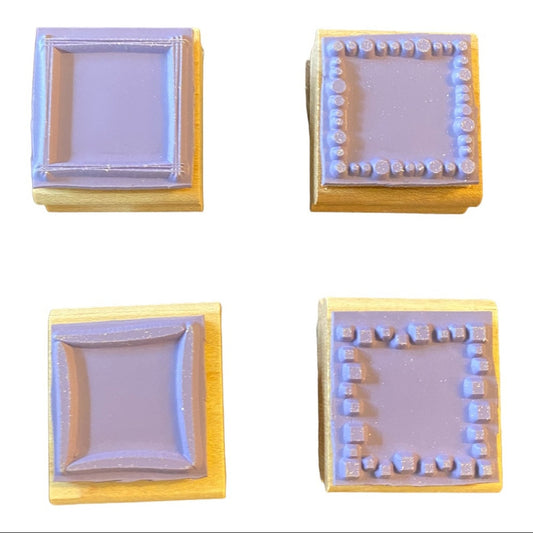 Four square rubber stamps with different patterns on a white background
