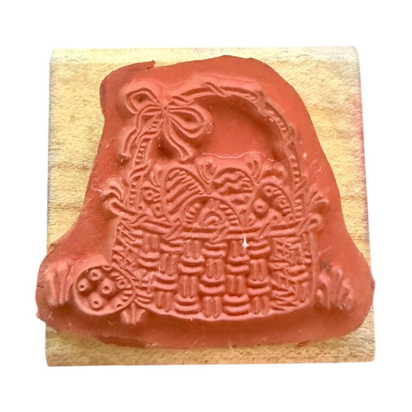 Decorative rubber stamp with basket design on a wooden block