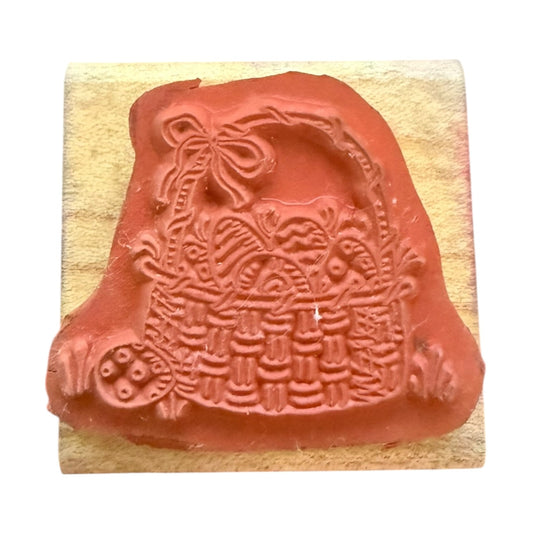 Decorative rubber stamp with intricate design on a wooden block