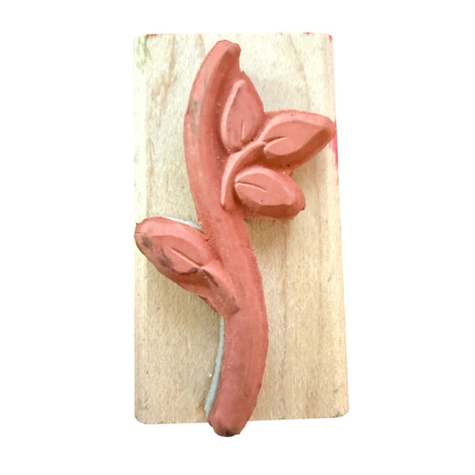 A vine rubber stamp mounted on a rectangular light wood block, shown against a plain white background.