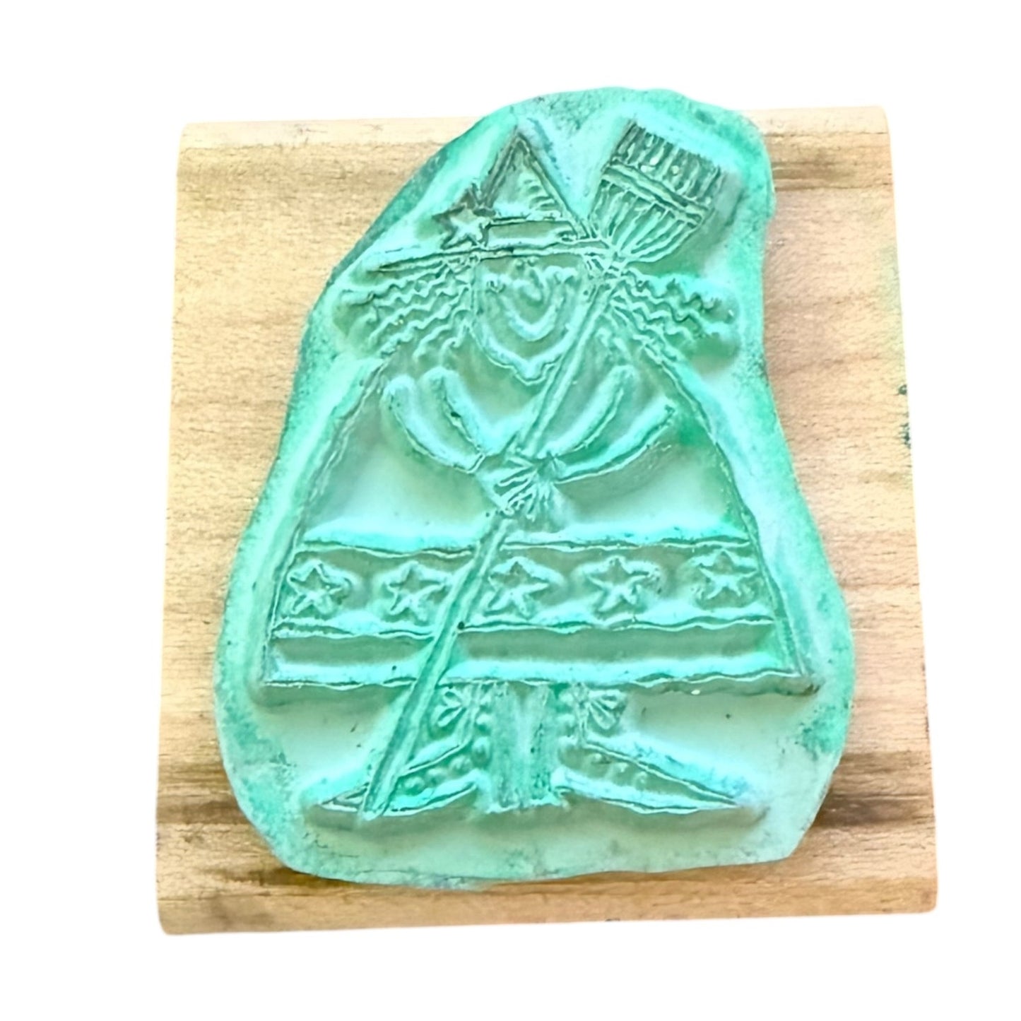 Teal witch rubber stamp with a design on a wooden block