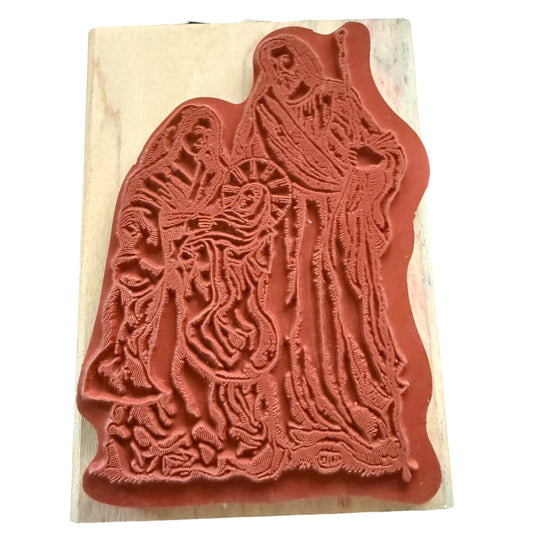Rubber stamp with intricate design of a religious scene on a beige background