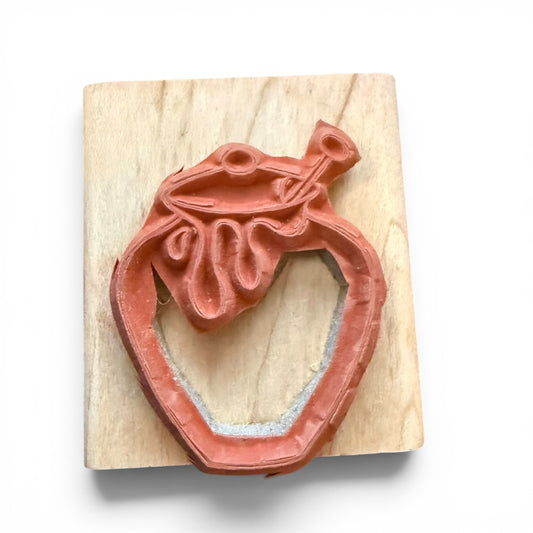 Wooden stamp with a honey pot design on a white background