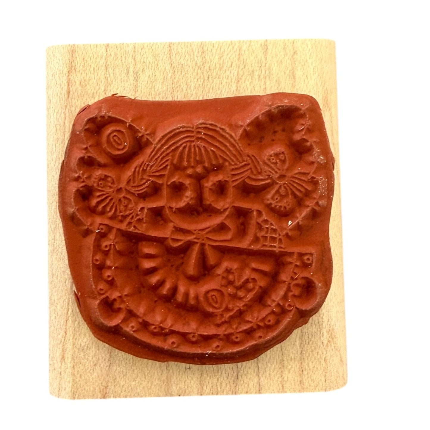 Decorative stamp with intricate design on a wooden block
