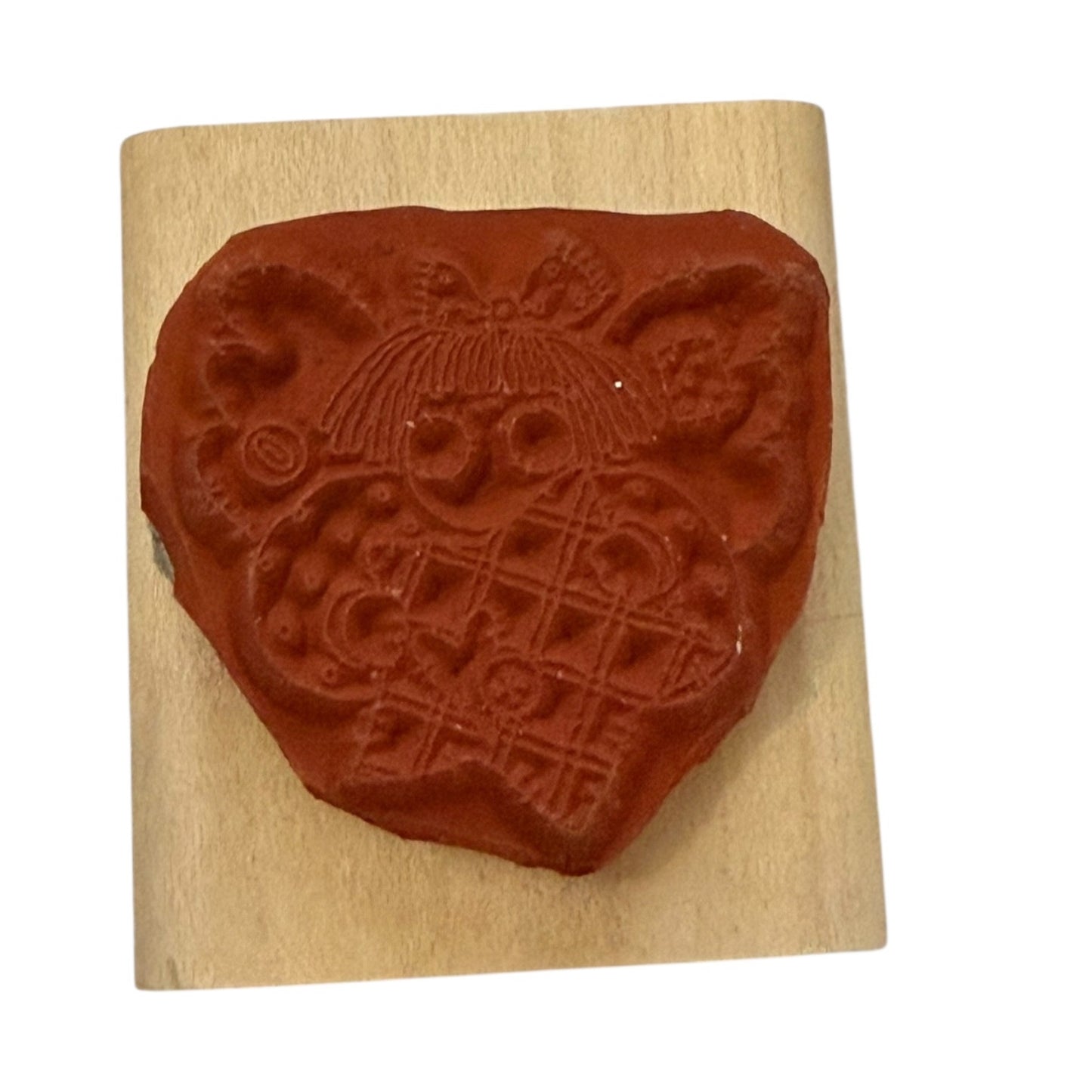 Decorative stamp with an angel design on a wooden block