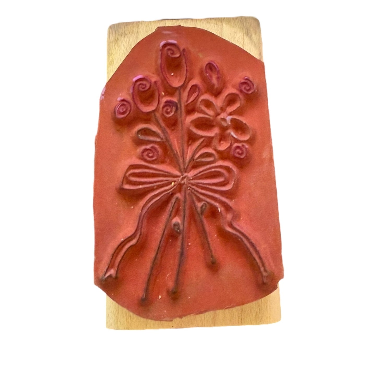 Rubber stamp with floral design on a wooden block