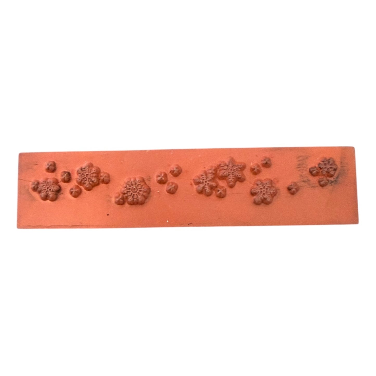 Rectangular stamp with snowflake designs on a white background