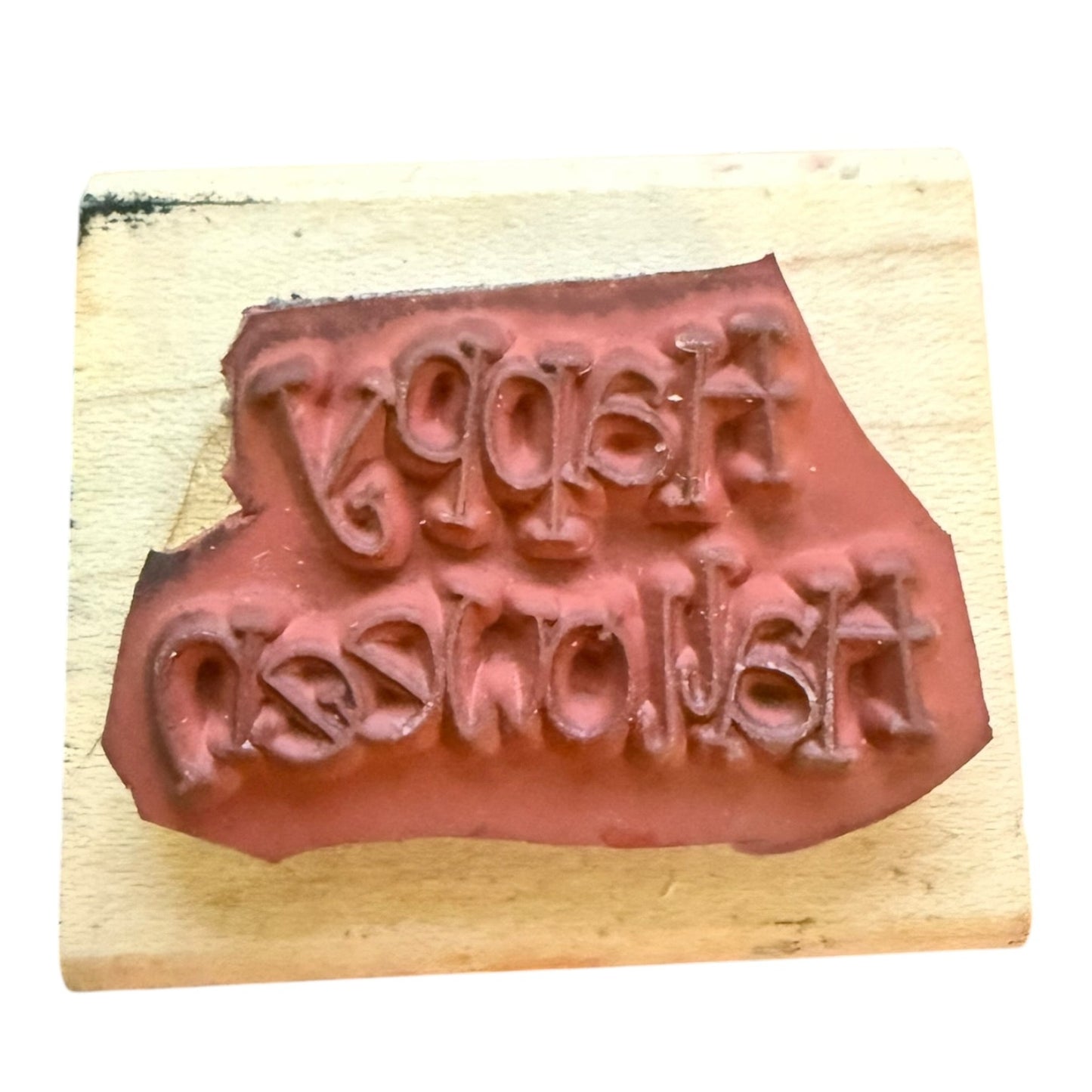 Rubber stamp with text on a wooden block