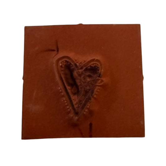 A square heart rubber stamp shown against a plain white background.