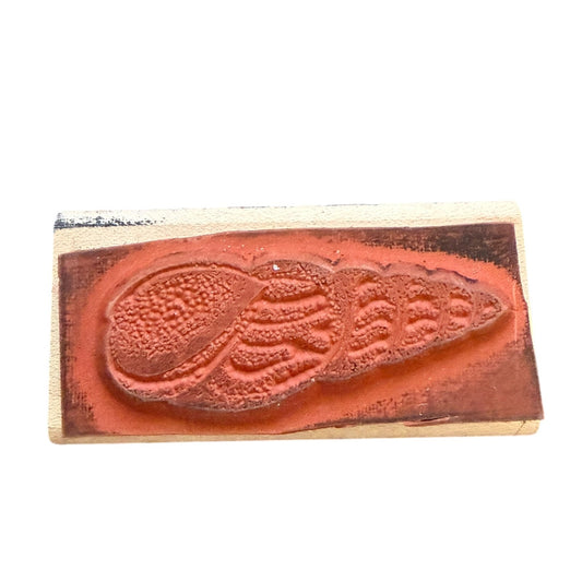 Wooden stamp with a textured design on a white background