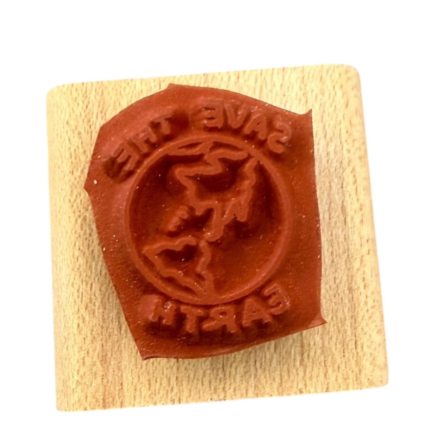 Wooden block with a red rubber stamp on a white background