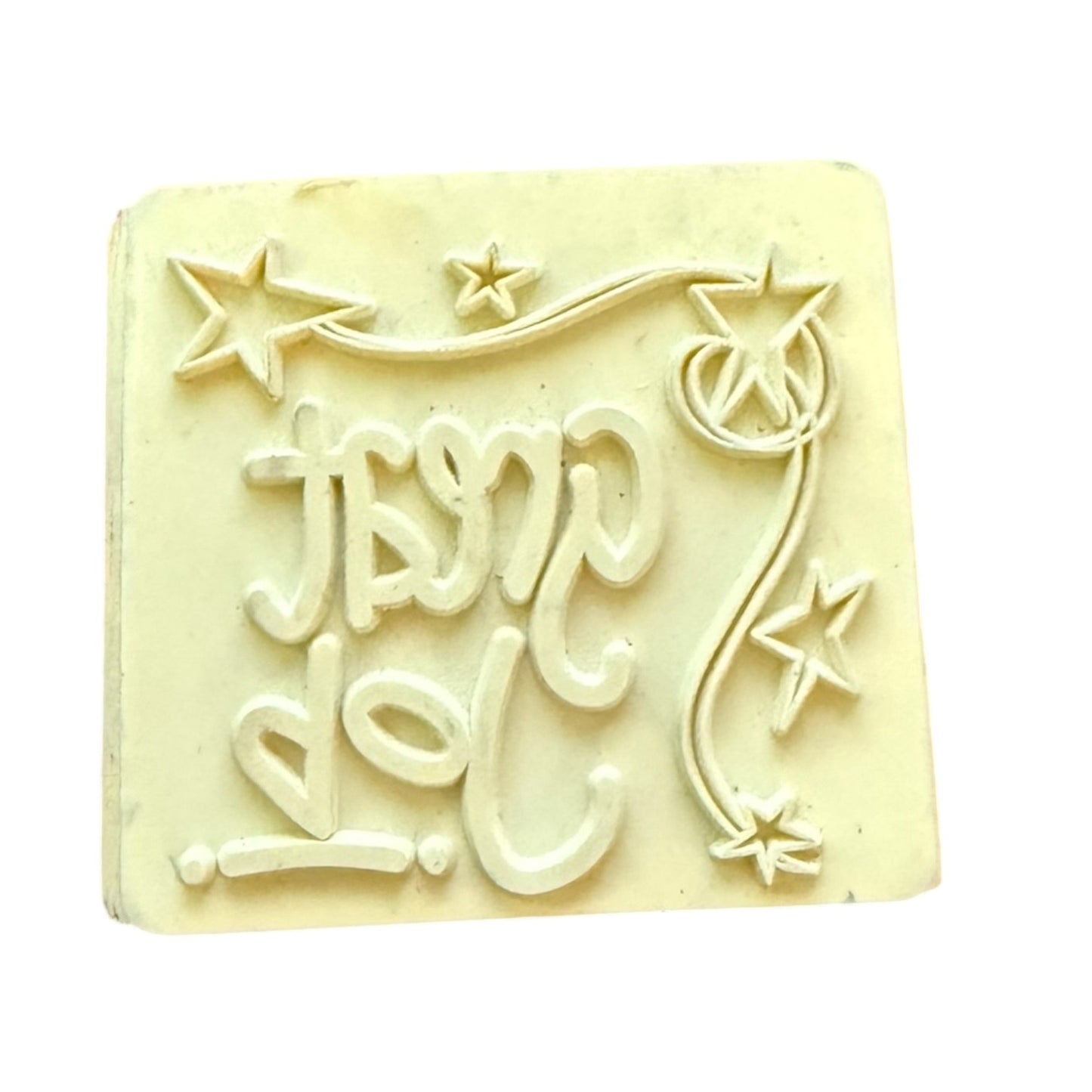 Rubber stamp with print and decorative stars, set against a plain white background