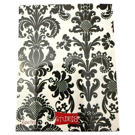 Notebook featuring a black and white damask floral design, with a red brand label reading 'STUDIO18' at the bottom.