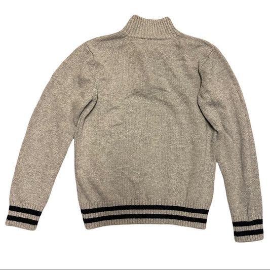 A gray knit sweater with a mock neck, shown from the back. It features black striped ribbed cuffs and hem.