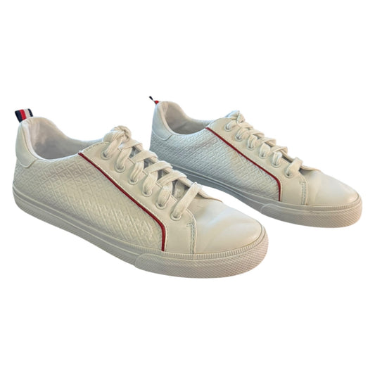 Pair of white sneakers with red accents on a white background