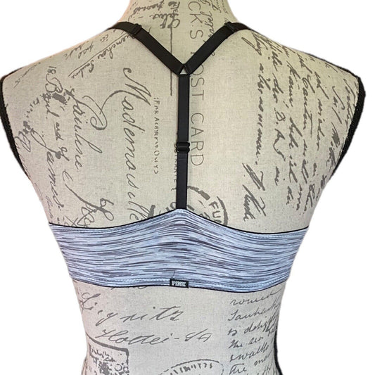 Back view of a bra with a patterned design on a mannequin.