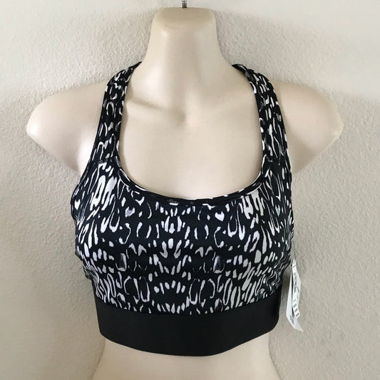 Black and white patterned sports bra on a mannequin against a plain background