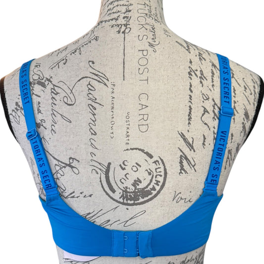 Victoria's Secret bra with blue straps on a mannequin with vintage-style design.