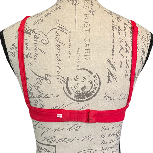 Back of bra with red straps on a mannequin against a white background