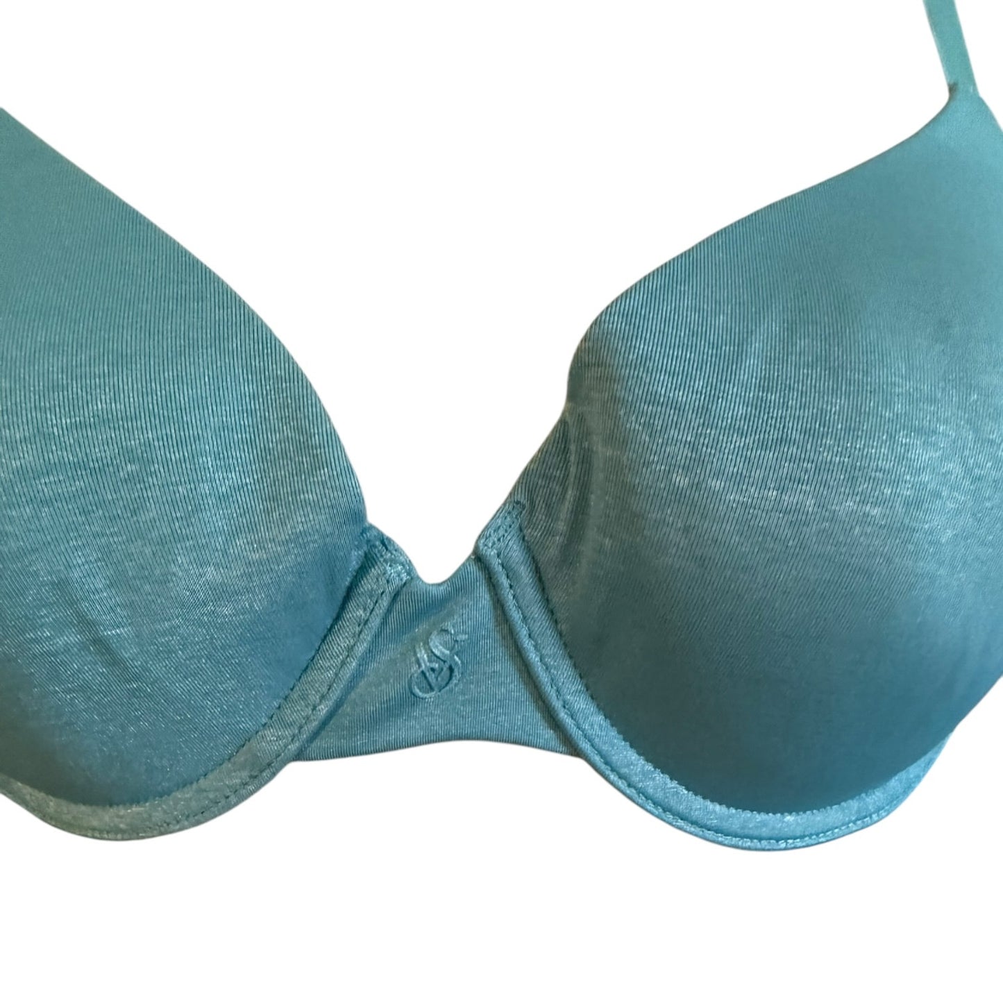A close-up of a blue underwire bra cup against a plain white background.