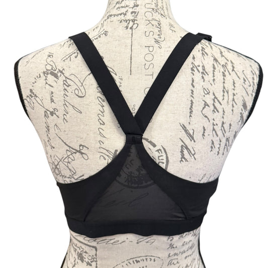 Black bra on a mannequin with a script patterned background